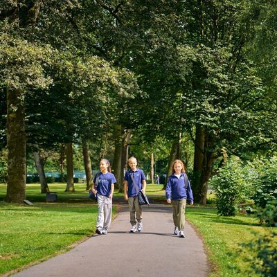 Bild vergr&ouml;&szlig;ern: Eine Gruppe junger Schulkinder wandern durch einen Park.